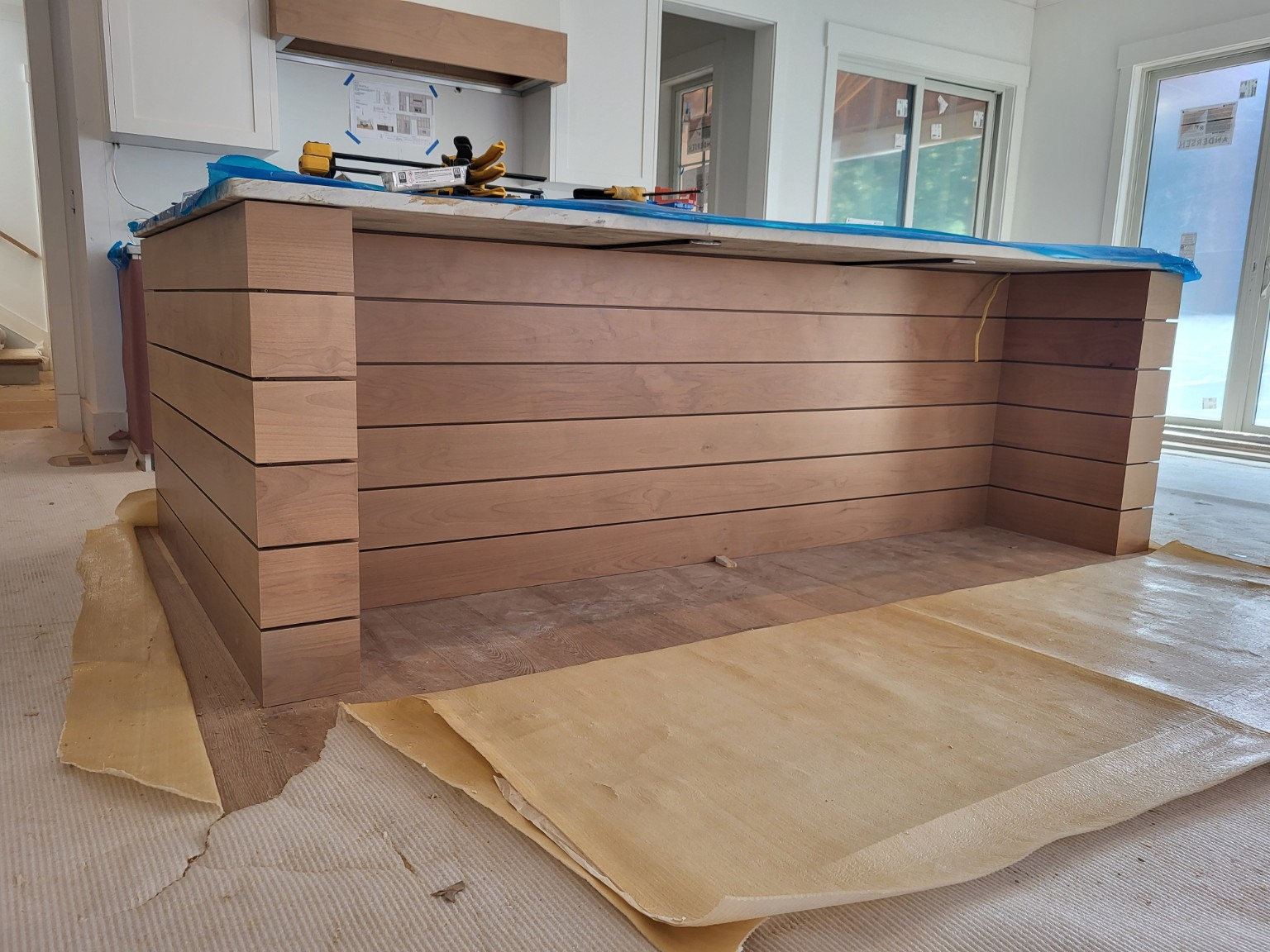 Custom wood-clad kitchen island during installation
