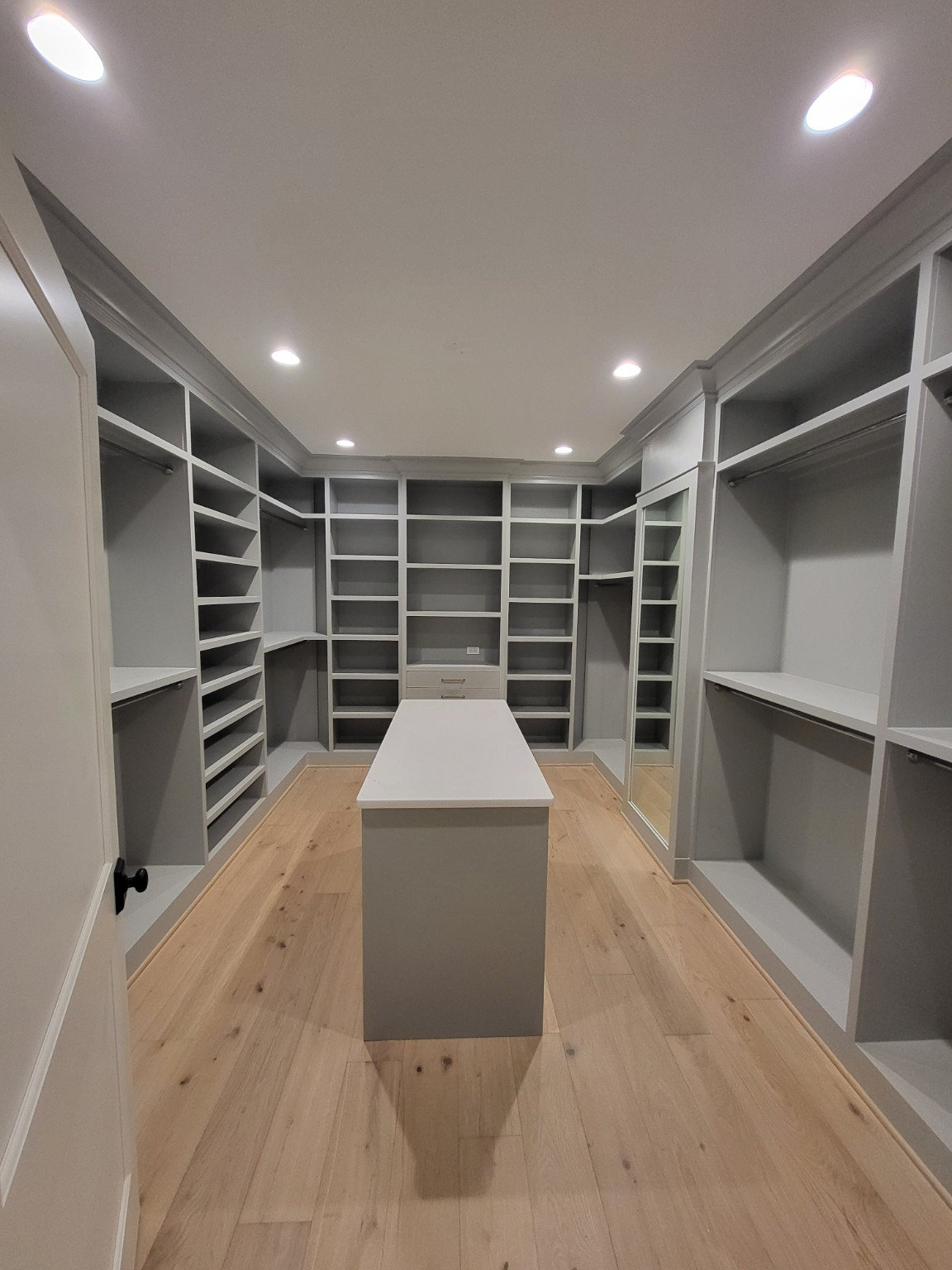 Walk-in closet with shelving and center island