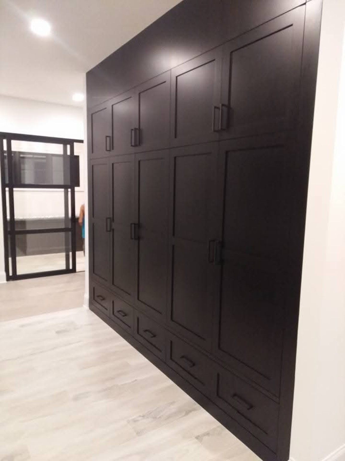 Dark floor-to-ceiling cabinetry