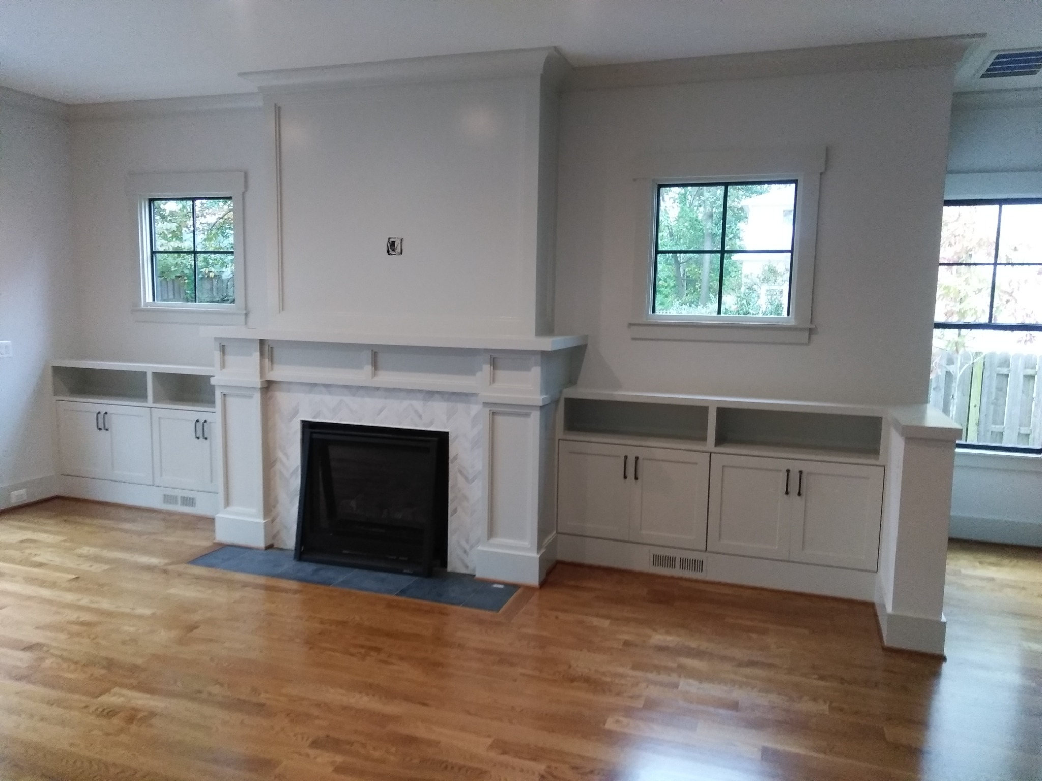 Fireplace surround and flanking cabinetry